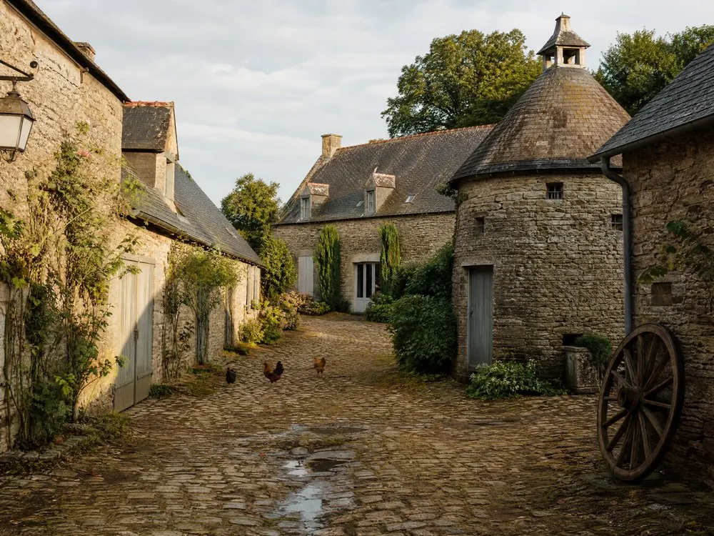 The cobbled farm court and its stone dovecote